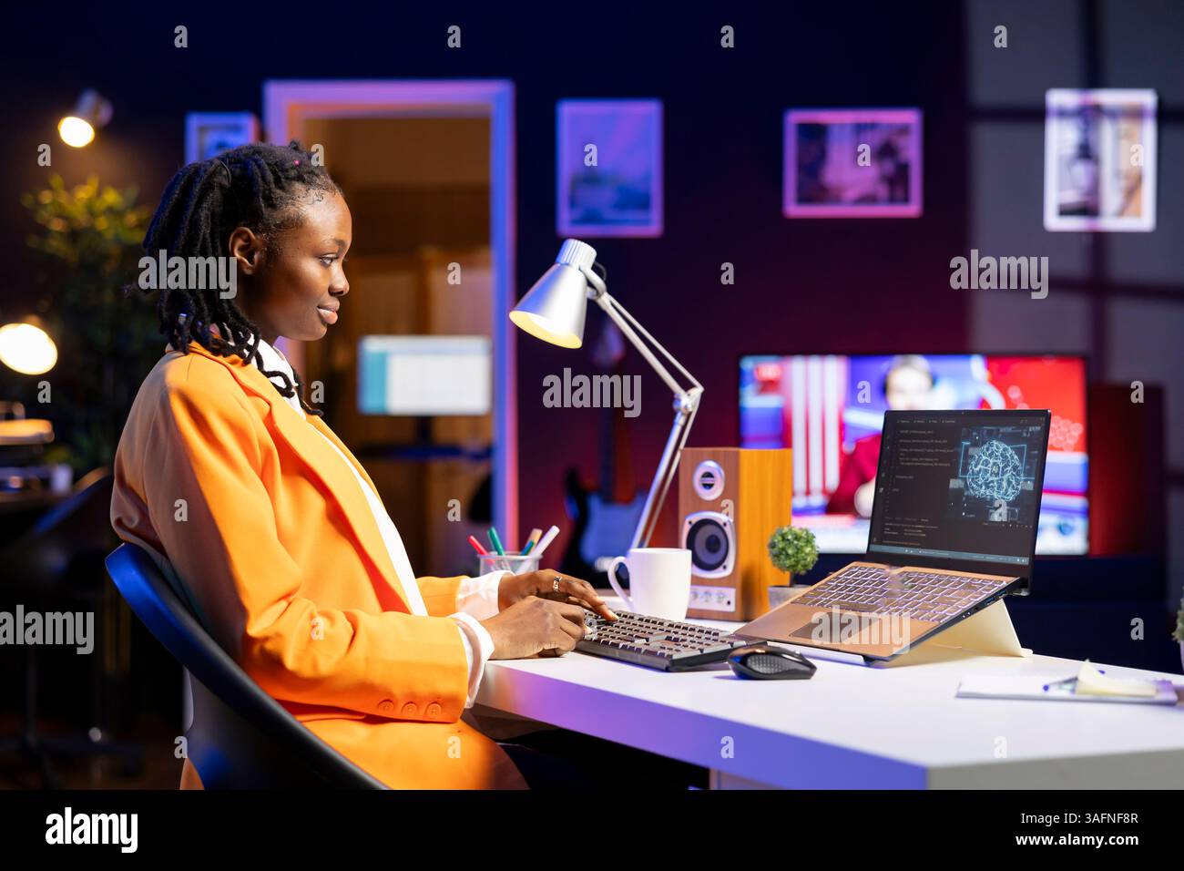 Freelancing computer engineer doing maintenance on artificial intelligence systems. Remote tech support specialist working from home, doing checkup on AI systems using laptop Stock Photo