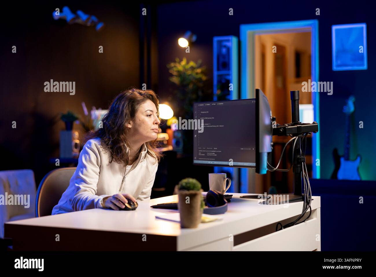 Developer typing code on computer to futureproof company network from downtimes and unexpected system failures. Woman deploying programming script increasing data security on desktop PC Stock Photo