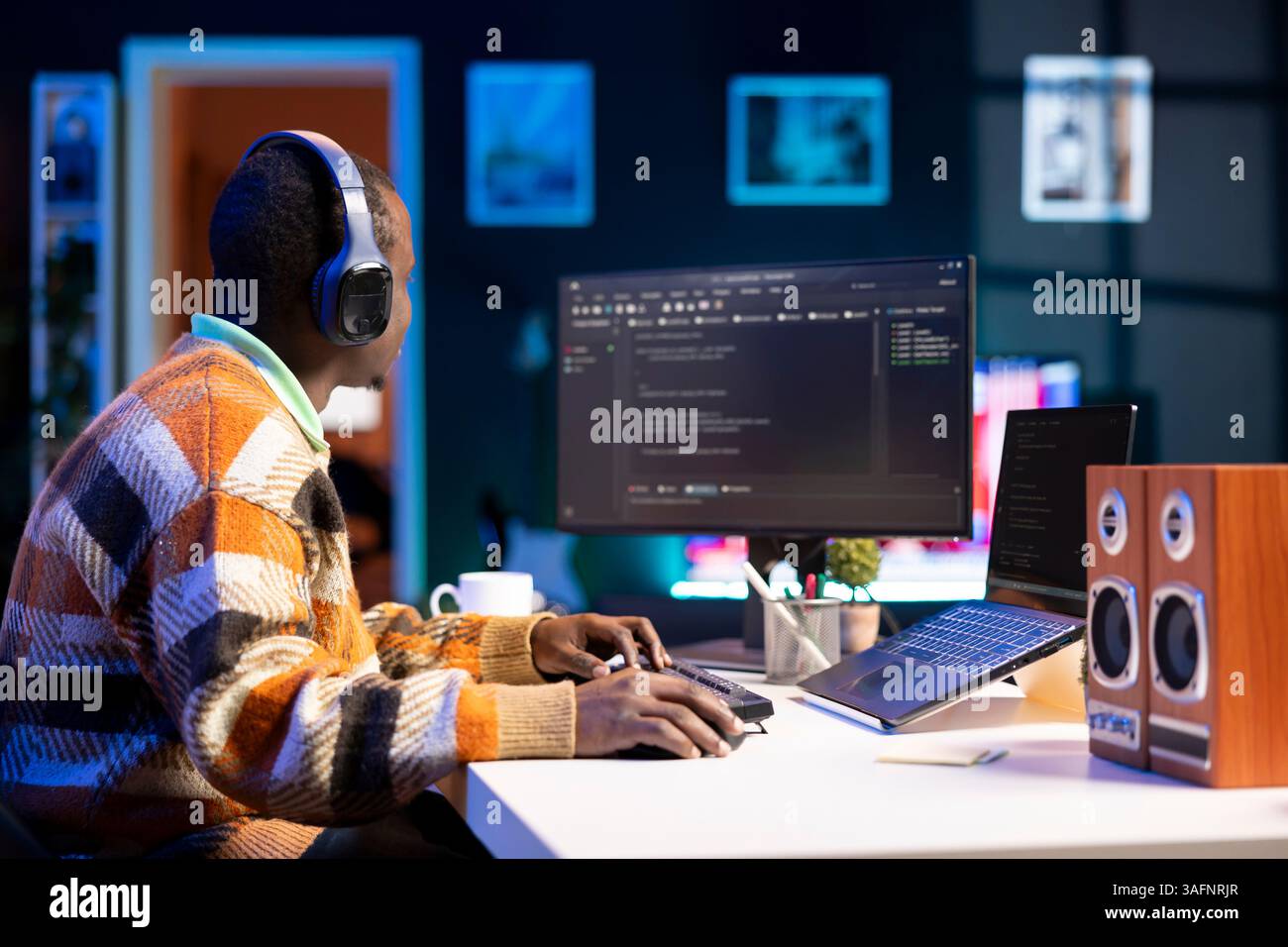 Male programmer working on developing new html script, typing binary code on terminal window. Young web developer does debugging work with coding language, database internet security. Stock Photo