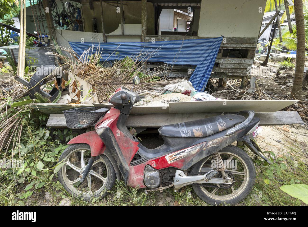 Old disused scooter in front of an abandoned house, Koh Mook, Andaman ...