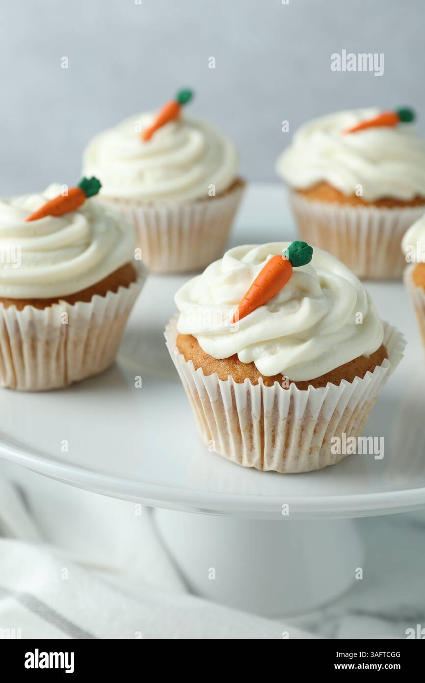 Delicious carrot cupcakes on table against grey background, closeup Stock Photo