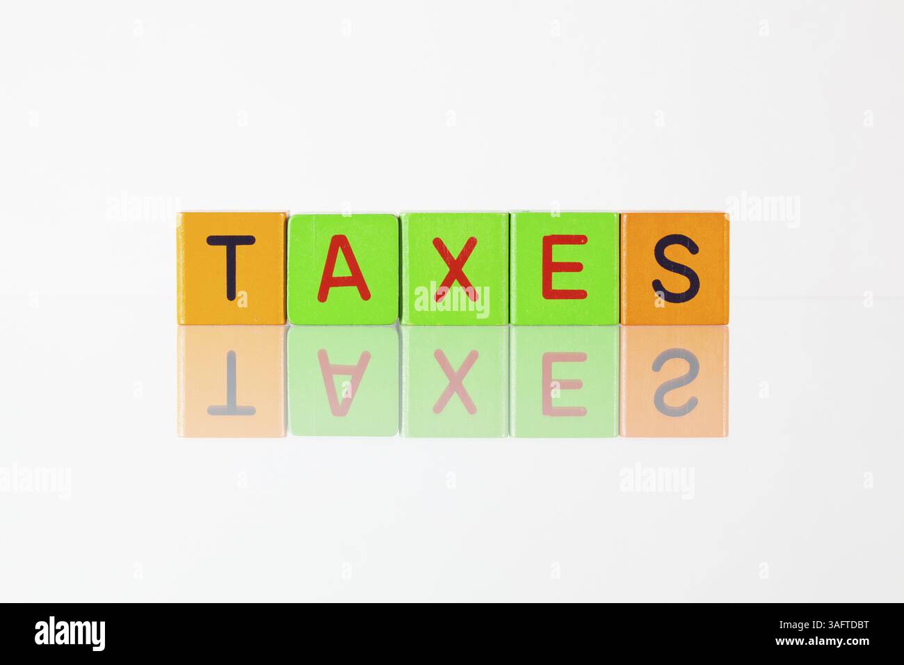 Taxes - an inscription from children's wooden blocks Stock Photo