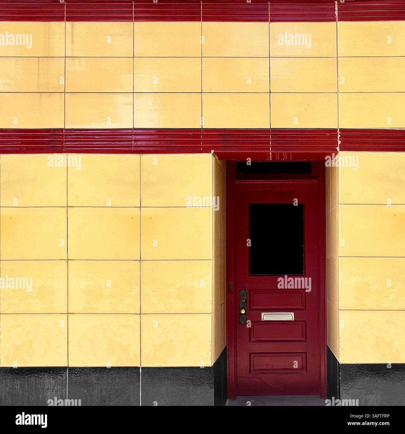 Streamline Moderne facade with yellow tile and red horizontal detailing in Chicago - Smartphone Captured Stock Image