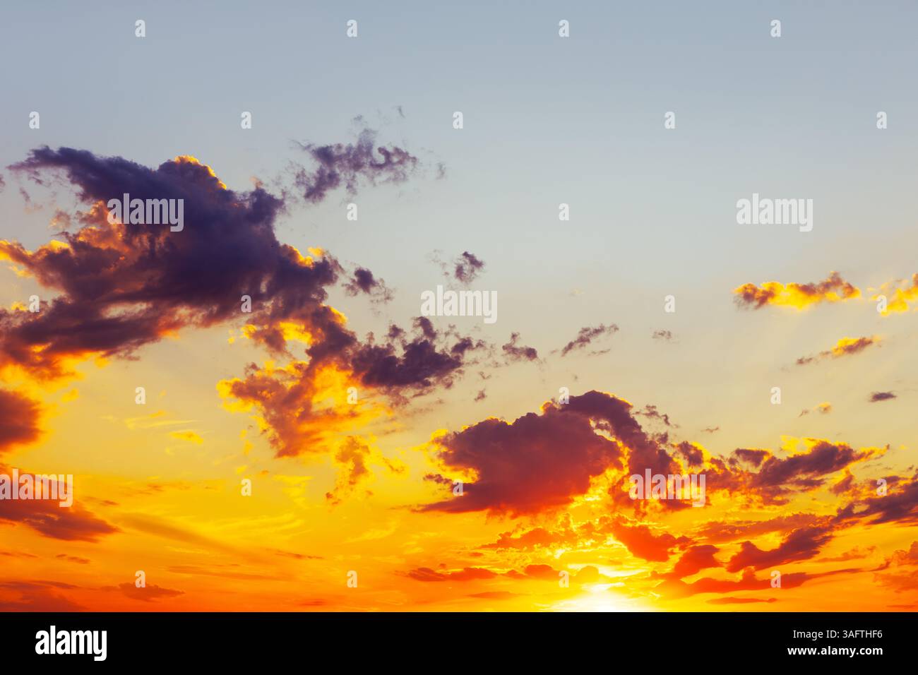 Vibrant sunset paints sky with orange and yellow Stock Photo - Alamy