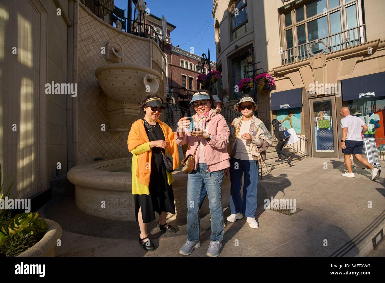 Tourists take photos in Rodeo Drive in Beverly Hills, Calif., on Monday ...
