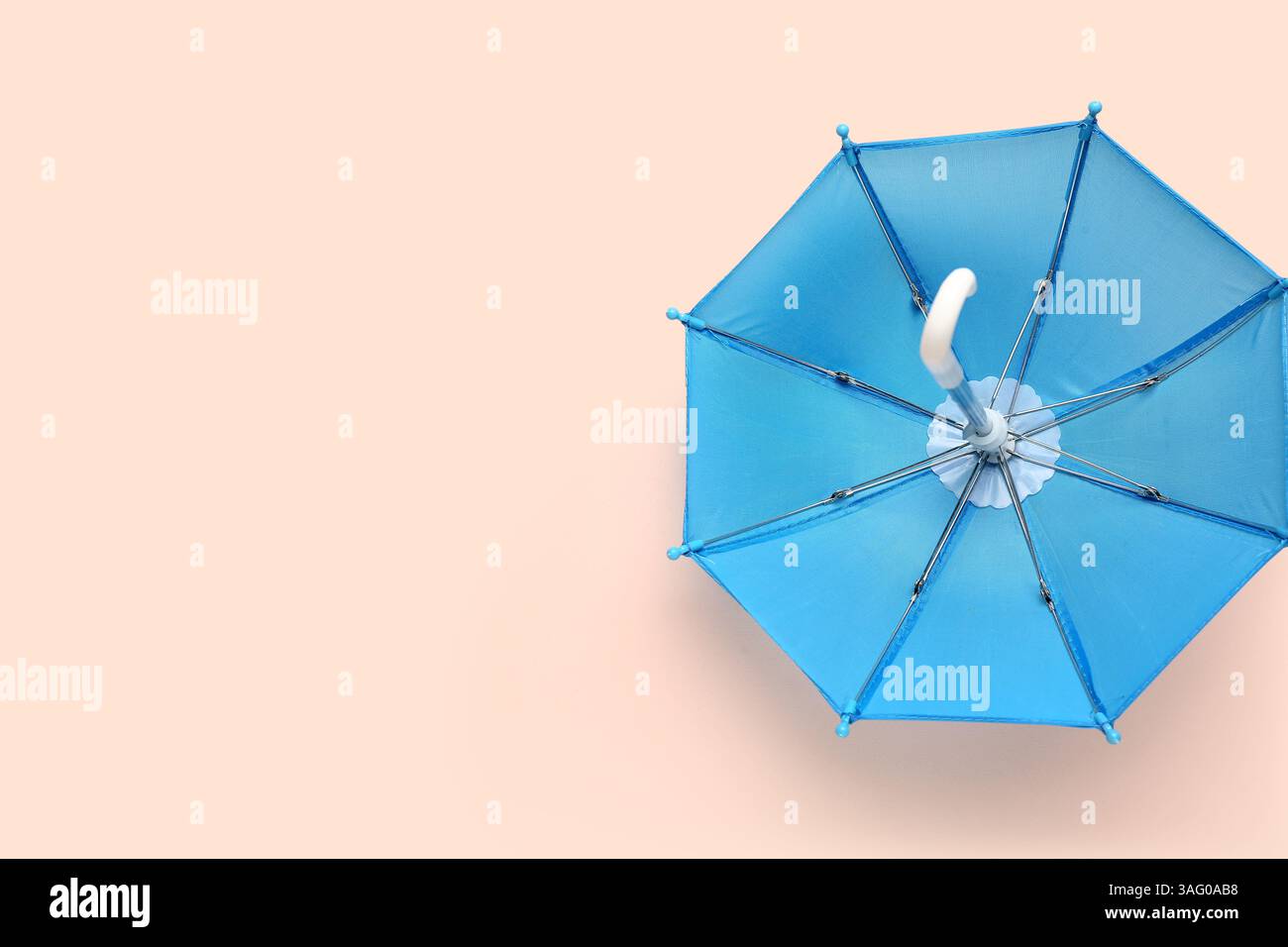 Mini stylish umbrella on beige background Stock Photo
