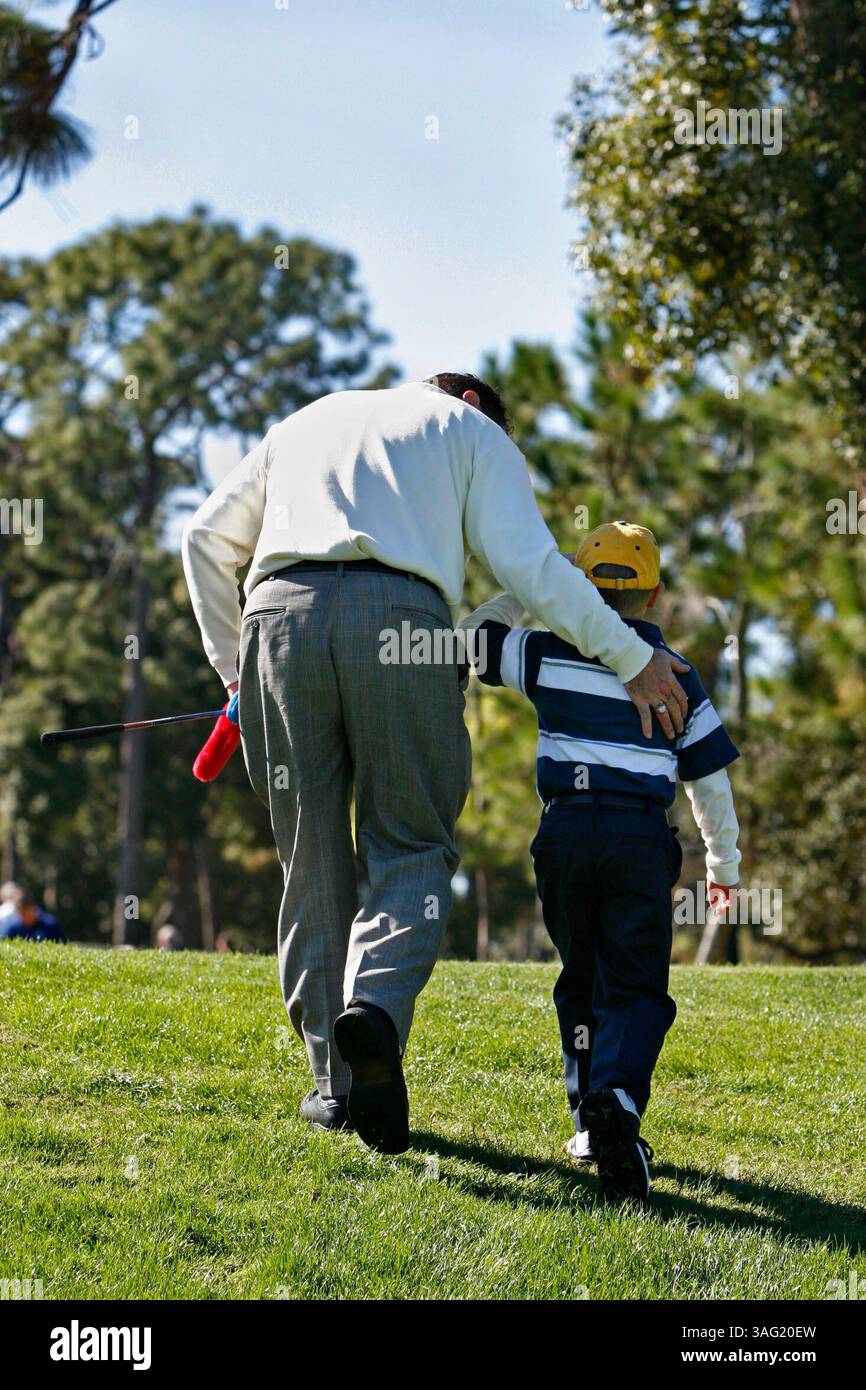 TARPON SPRINGS 12/5/2007 ) photo #6.) Demetri Kotsovolos heads off the practice range with his son Demetri Kotsovolos at the Carrabba's Italian Grill Charity Golf Classic. - Young cancer patient (Credit Image: St Petersburg Times/ZUMAPRESS.com) Stock Photo