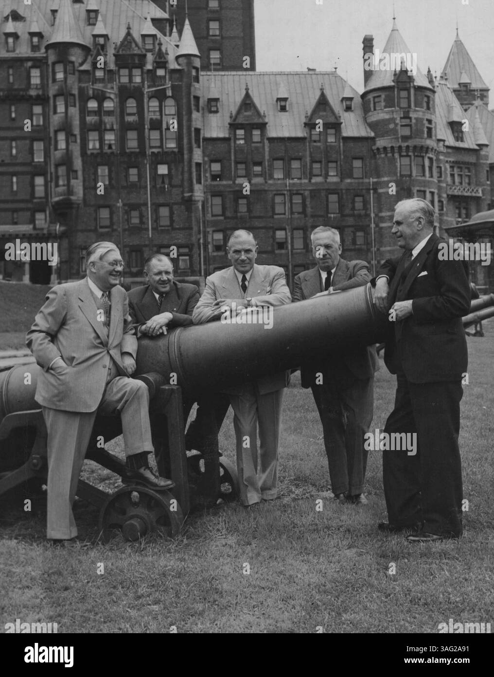 Press Conference - Mr Roy Thomson (left), of the Thomson Dailies, and treasurer of the Canadian section of the Imperial Press Conference in Quebec, chats with Major C. G. Dunn (fourth from left), president of the Quebec Chronicle Telegraph, and three Australian delegates - Sir Gordon B. Rolph (second from left), governing director, W. R. Rolph and Sons, proprietors of the Examiner and Saturday Evening Express, • Sir John Butters (centre), chairman of Associated Newspapers Limited, Sydney, and Sir Keith Murdoch, leader of the Australian delegation.  June 20, 1950. (Photo by Canadian Pacific Rai Stock Photo