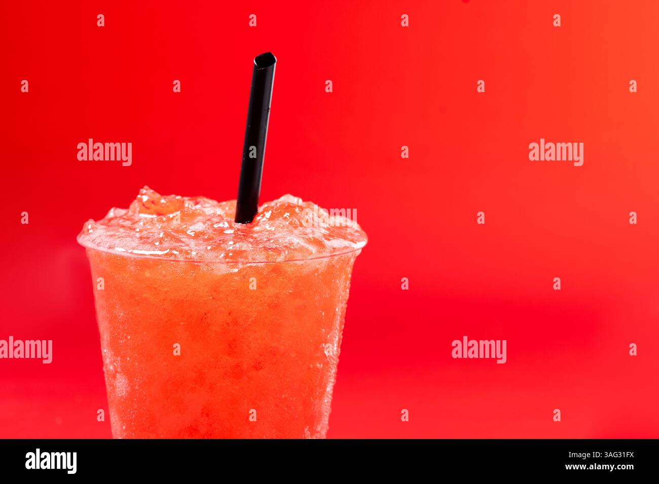 Red strawberry slushie isolated on red background Stock Photo