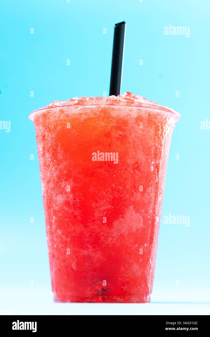 Red strawberry slushie isolated on blue background Stock Photo