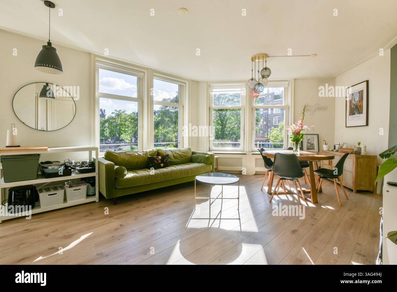 A spacious living room featuring large windows that allow natural light ...