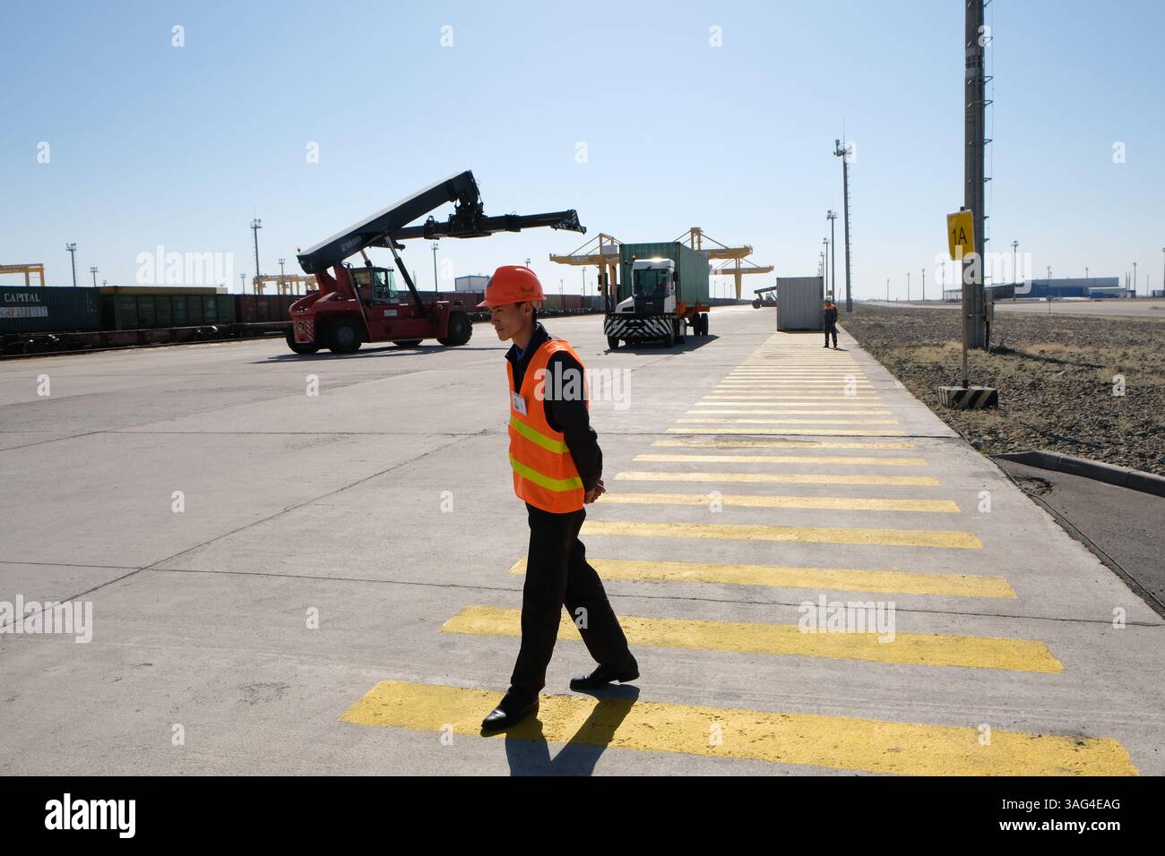 A security and control officer monitors the unloading of containers ...