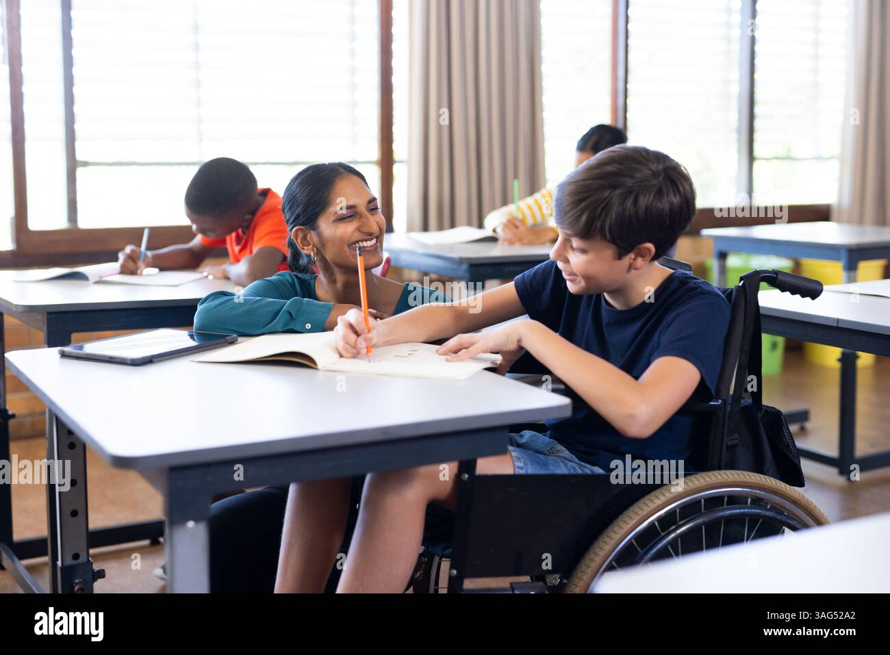 Student in wheelchair writing hi-res stock photography and images - Alamy, image size:1300x957