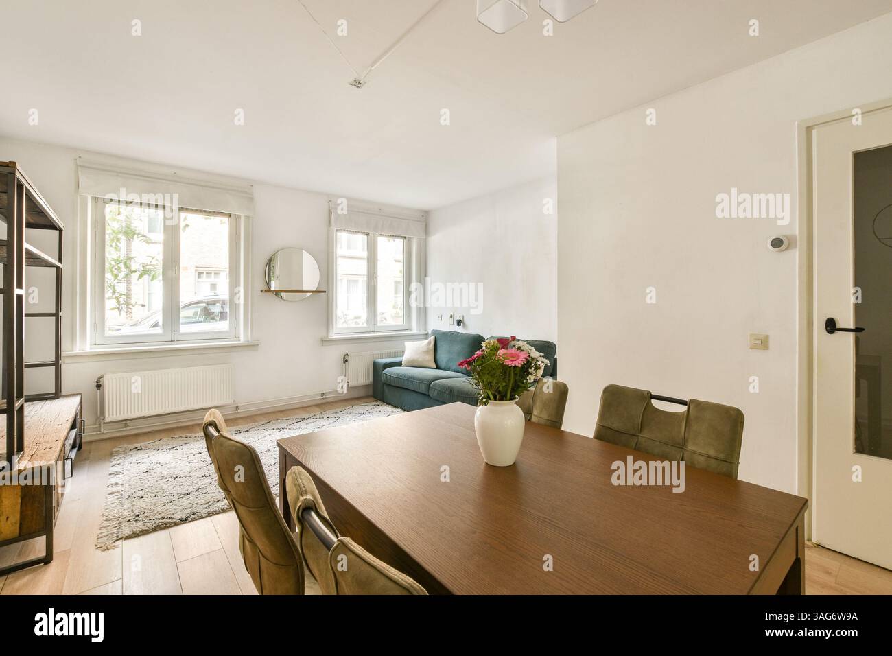 Bright and airy modern interior featuring a wooden dining table ...