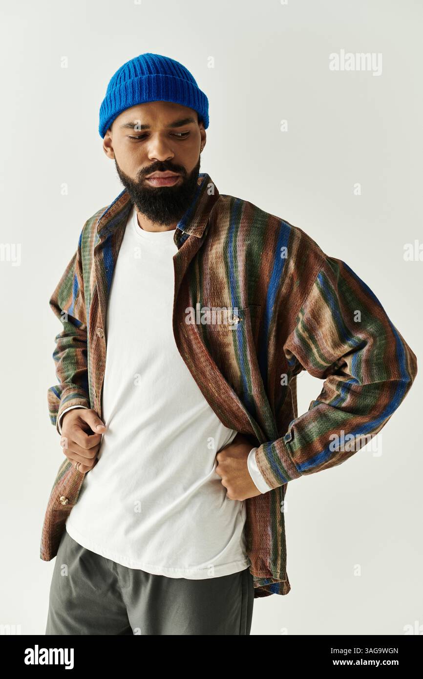 Stylish young man confidently displays trendy outfit in a bright and ...
