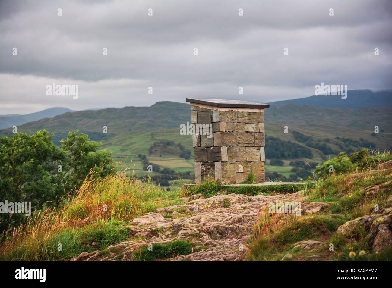 Stone viewpoint marker overlooking the scenic hills and valleys of the ...