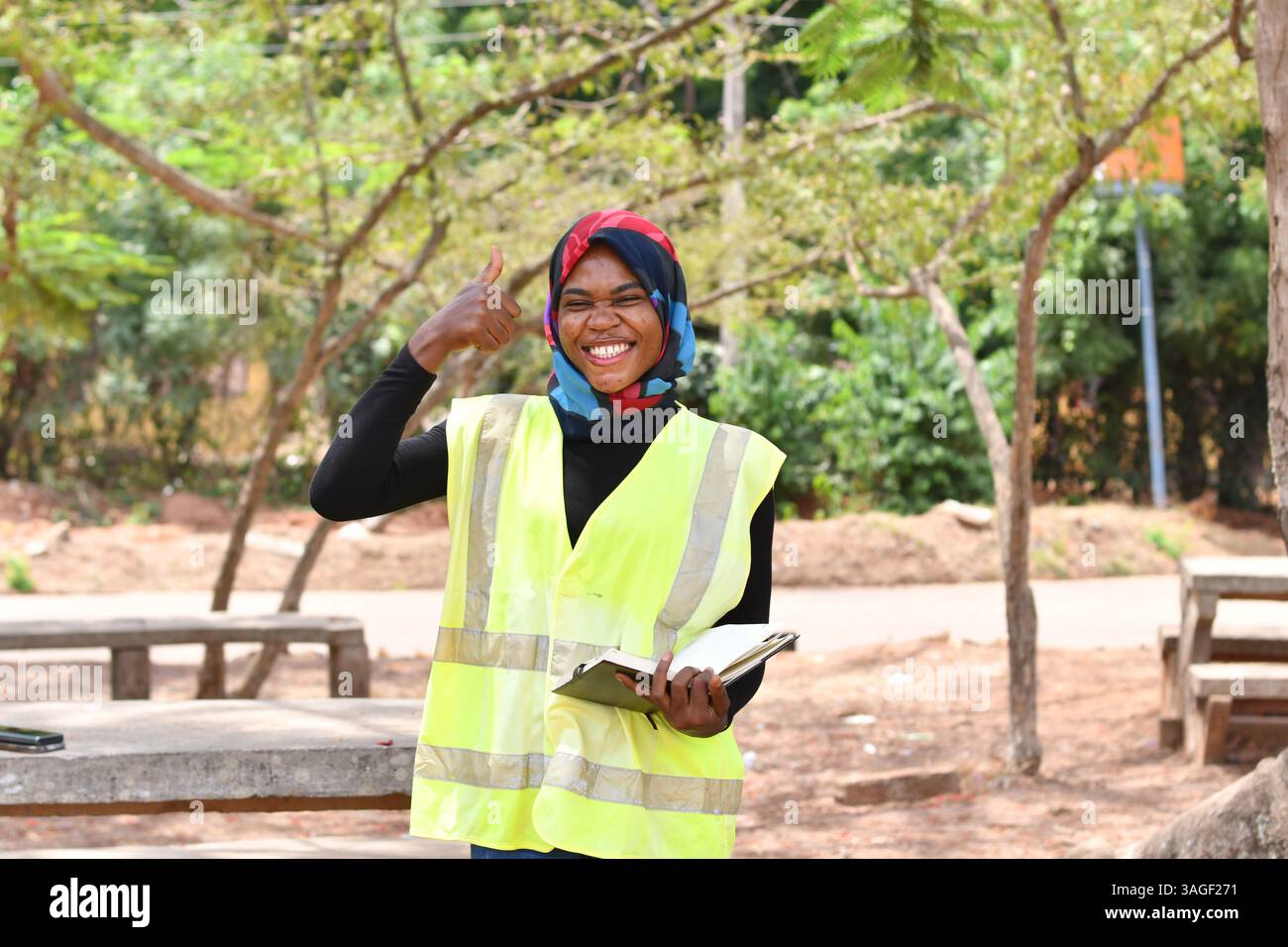 Female architect looking at blueprints on construction site Stock Photo ...