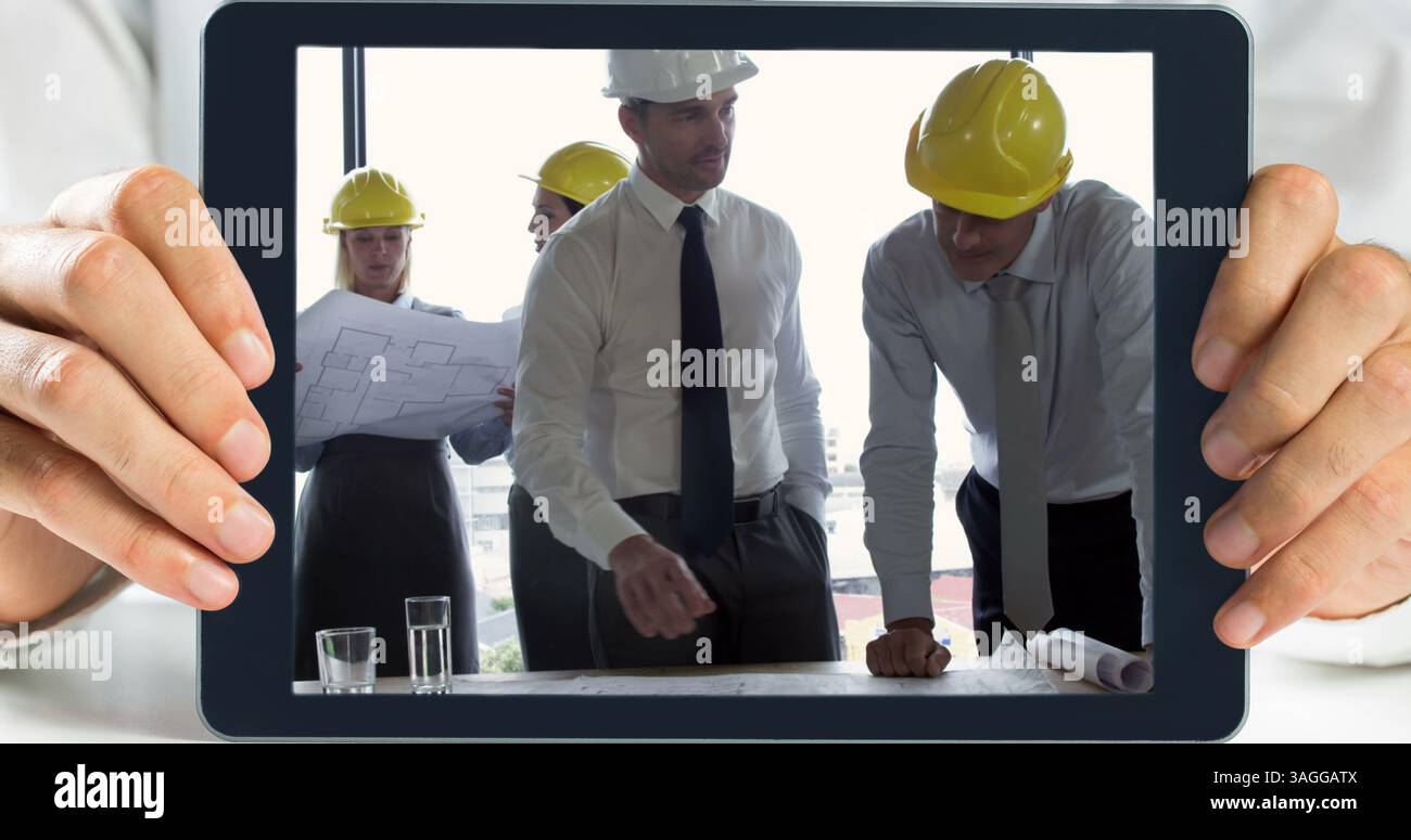 Hands holding digital tablet showing architect working Stock Photo