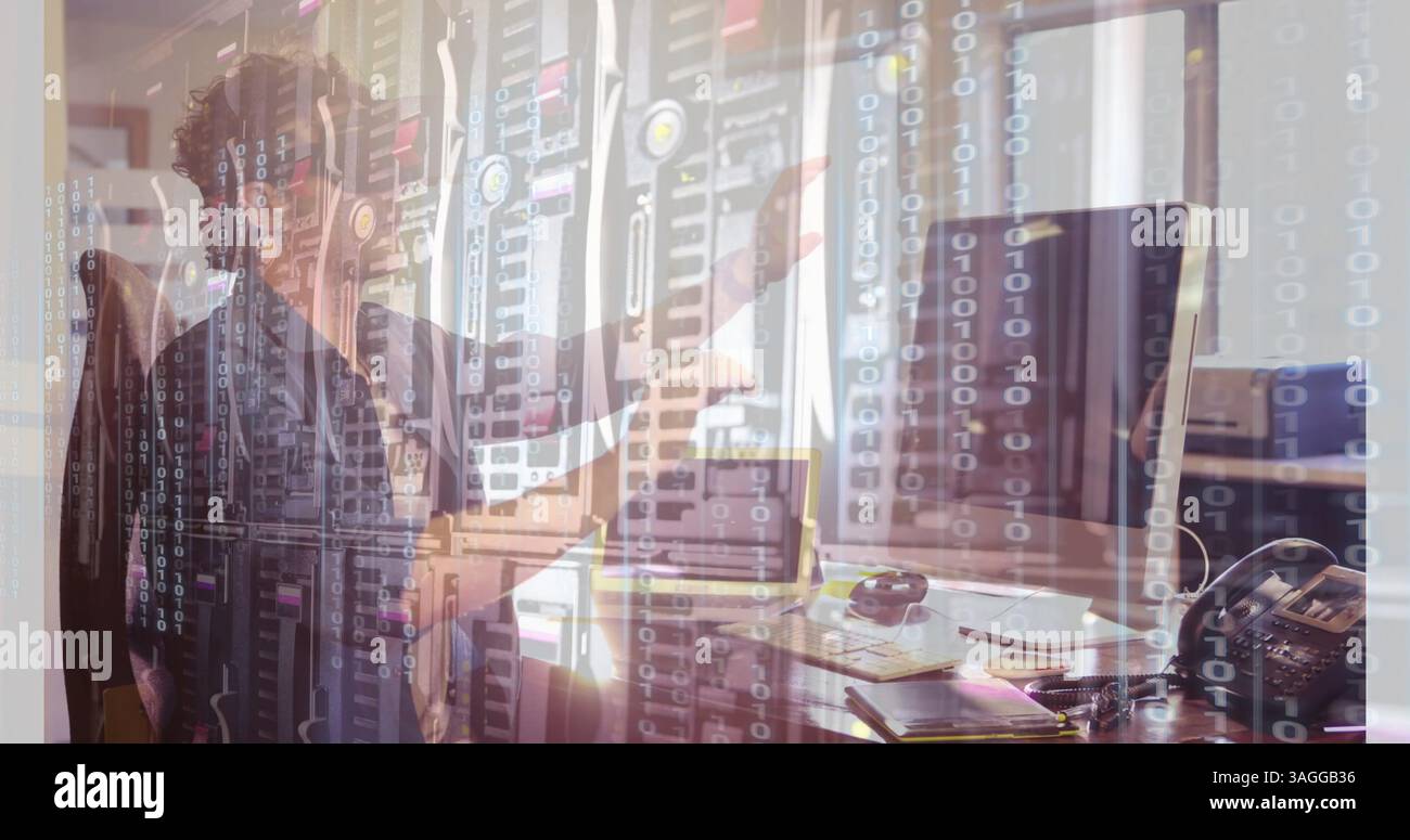 Binary code and data servers over person working at computer in office Stock Photo