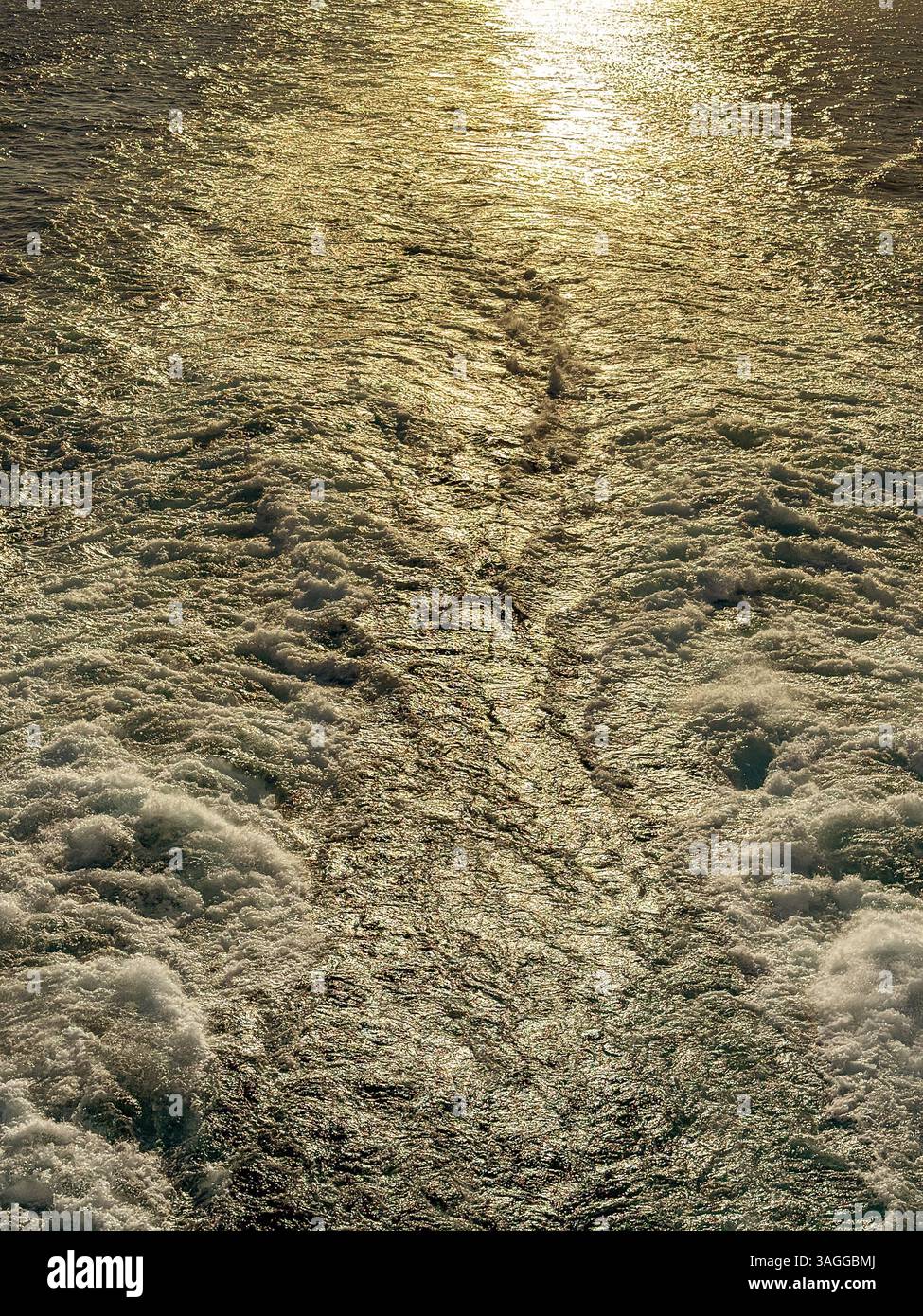 Seascape  of the wake of a cruise ship with the sun low over the horizon. Backgrounds, Cruise vacation concept. No people. - Smartphone Captured Stock Image