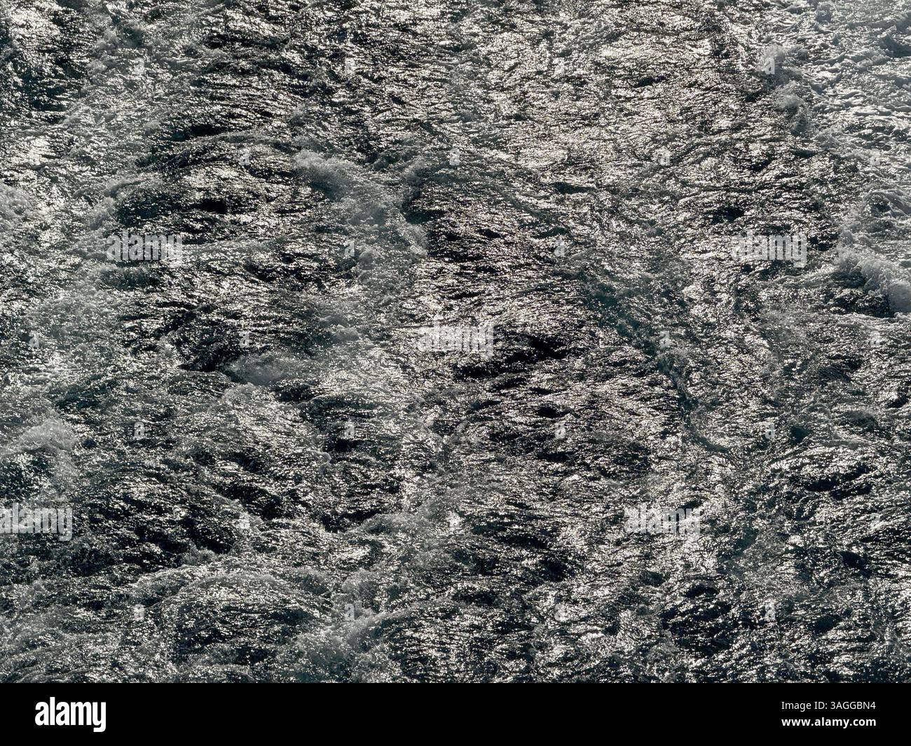 Pattern formed by the turbulent waters in the wake of the powerful engines of a cruise ship at sea. Backgrounds. Cruise vacation concept. No people. - Smartphone Captured Stock Image