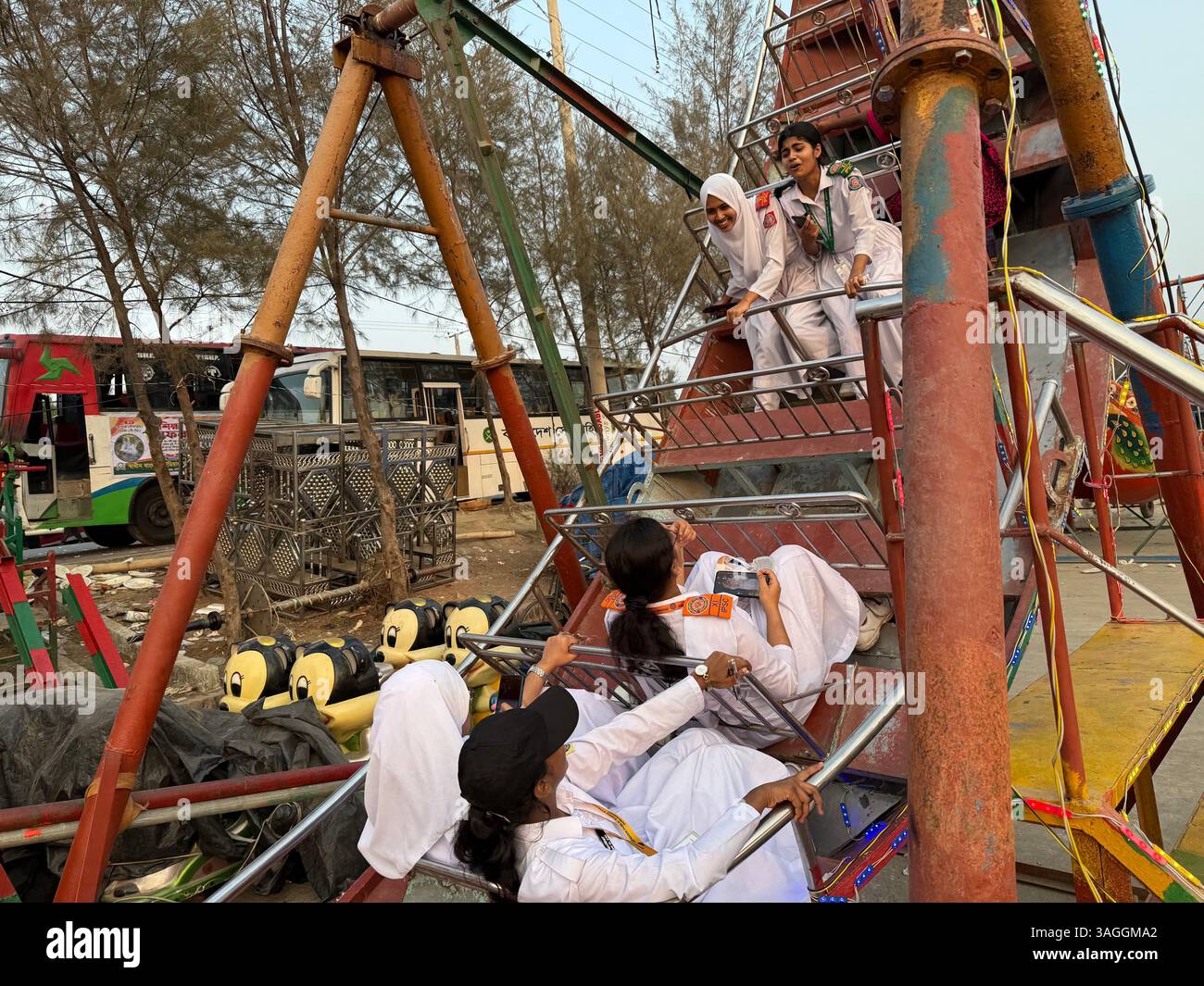 Bangladeshi Muslim veiled female students enjoying rides in a small ...
