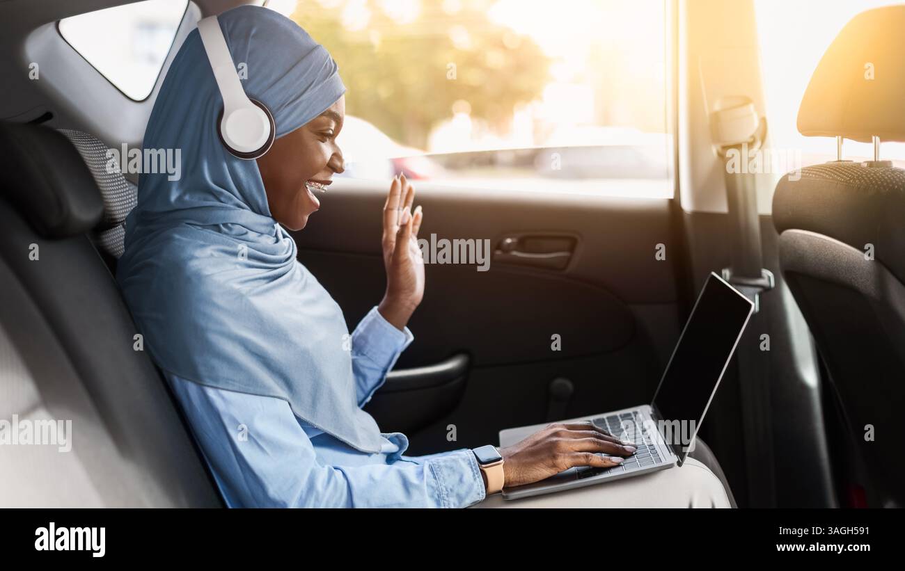 Black Islamic Lady In Hijab Making Video Call With Laptop In Car Stock ...