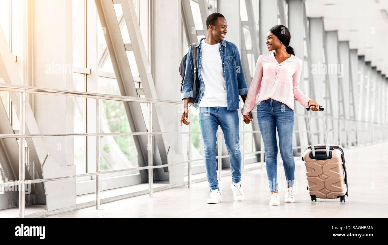 Journey Together. Smiling Black Spouses Walking With Luggage In Airport ...