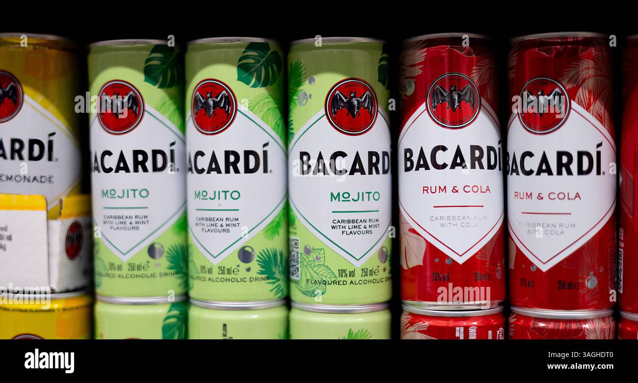 Brightly colored Bacardi cocktail cans lined up, showcasing refreshing flavors for summer parties and gatherings. - FRANKFURT, GERMANY - MARCH 21, 202 Stock Photo