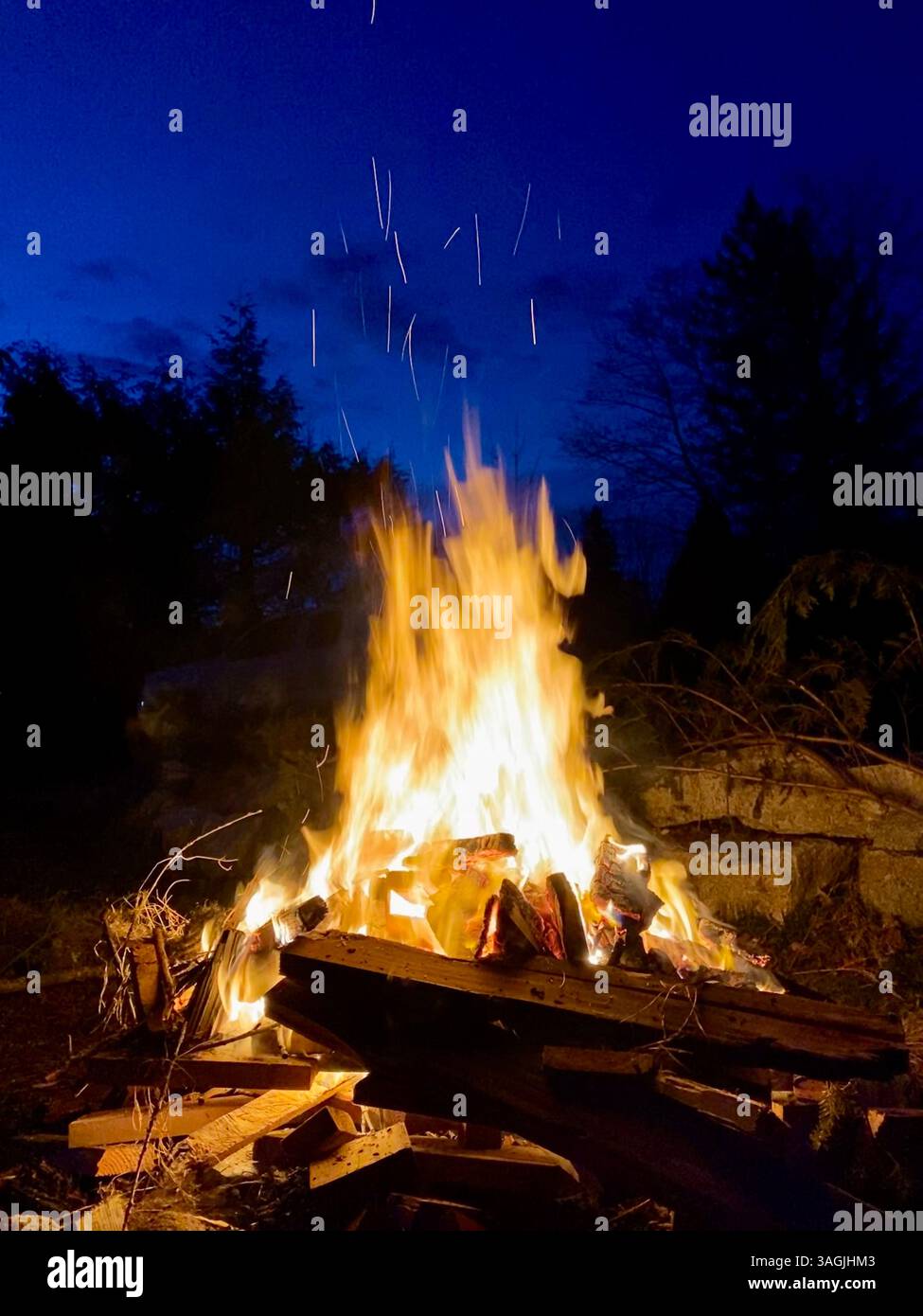 Blazing Bonfire Beneath Twilight Skies - Smartphone Captured Stock Image