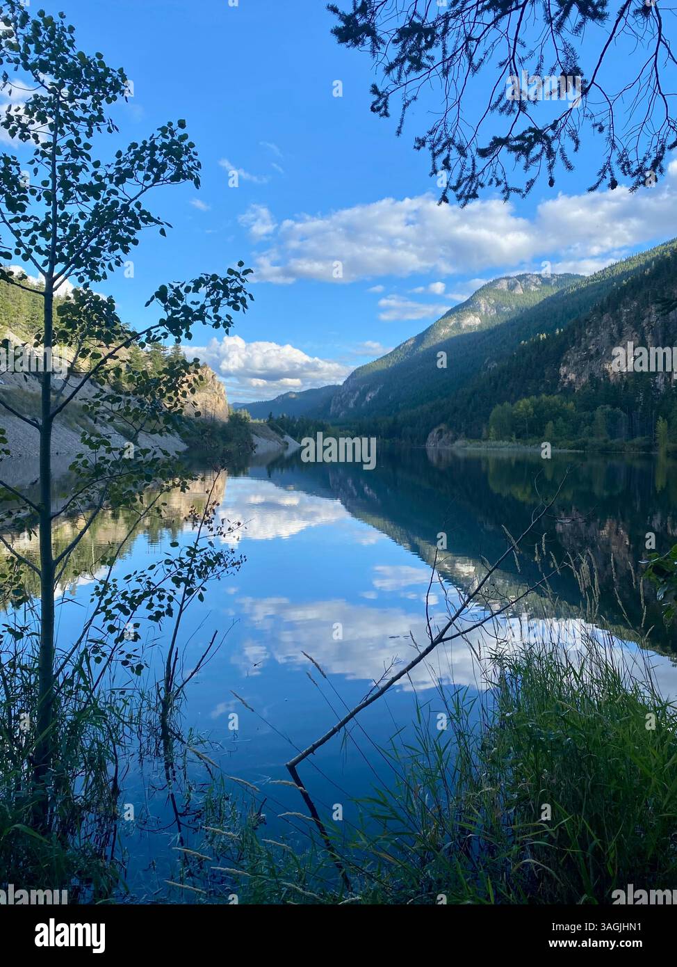 Crystal-Clear Reflections on a Mountain Lake - Smartphone Captured Stock Image