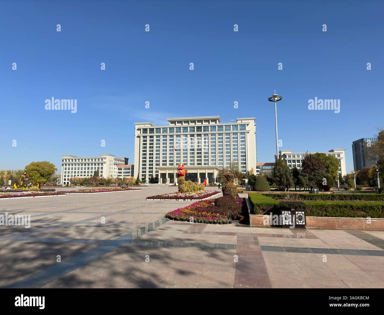 The imposing architecture of a modern building complex dominates a bright, sunny day. - Smartphone Captured Stock Image The imposing architecture of a modern building complex dominates a bright, sunny day. - Smartphone Captured Stock Image