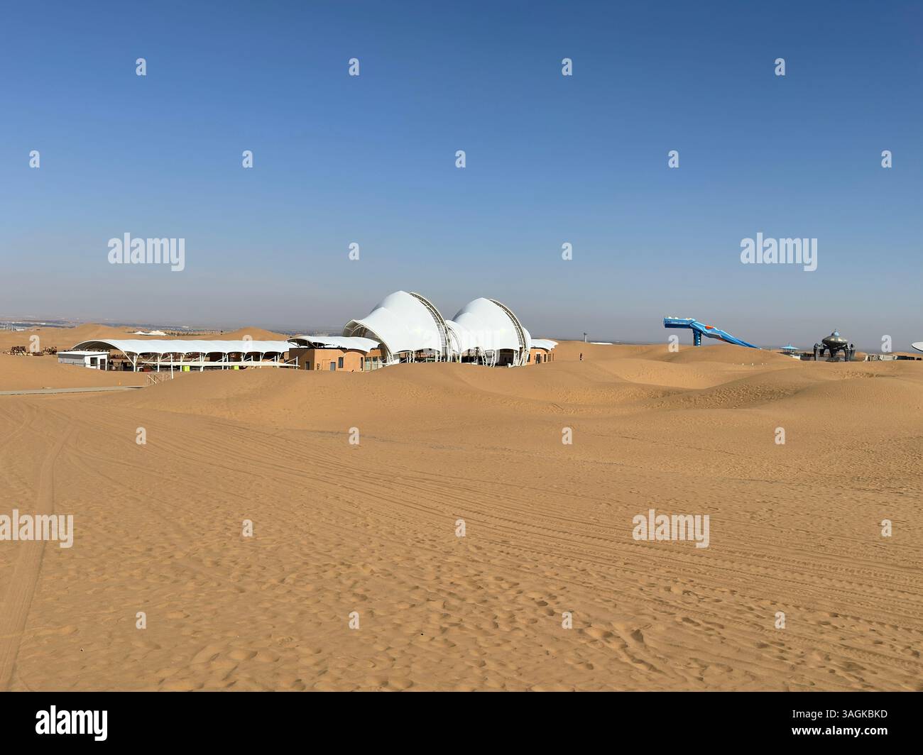 Desert landscape with buildings and tents under a clear blue sky in west of China - Smartphone Captured Stock Image