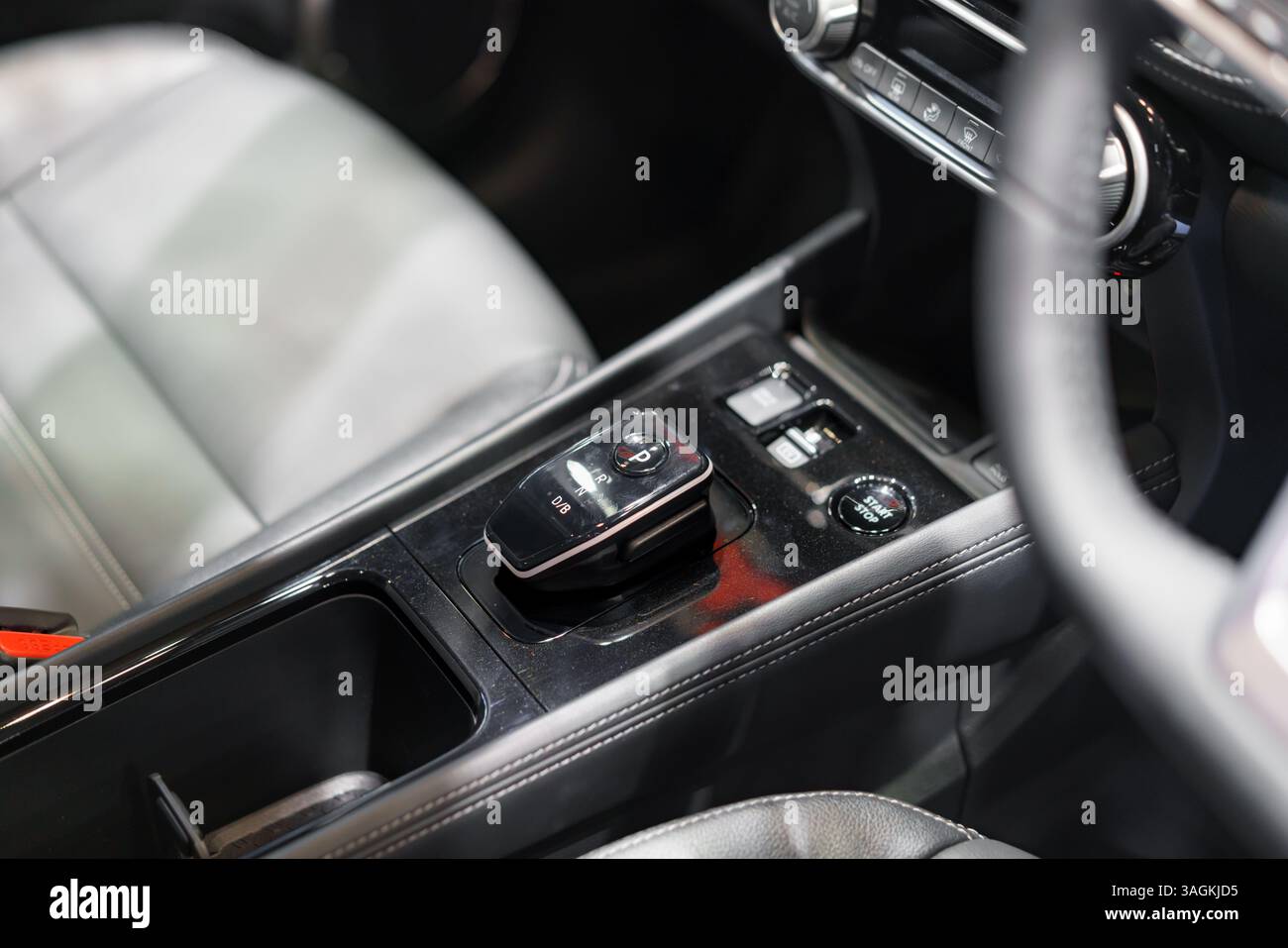 sleek center console displaying an automatic gear selector, start-stop ...