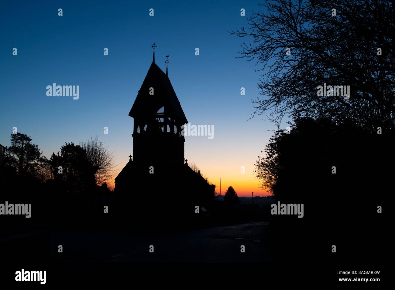 The bell tower All Saints Church silhouette at dawn. Great Bourton. Oxfordshire. England. Stock Photo