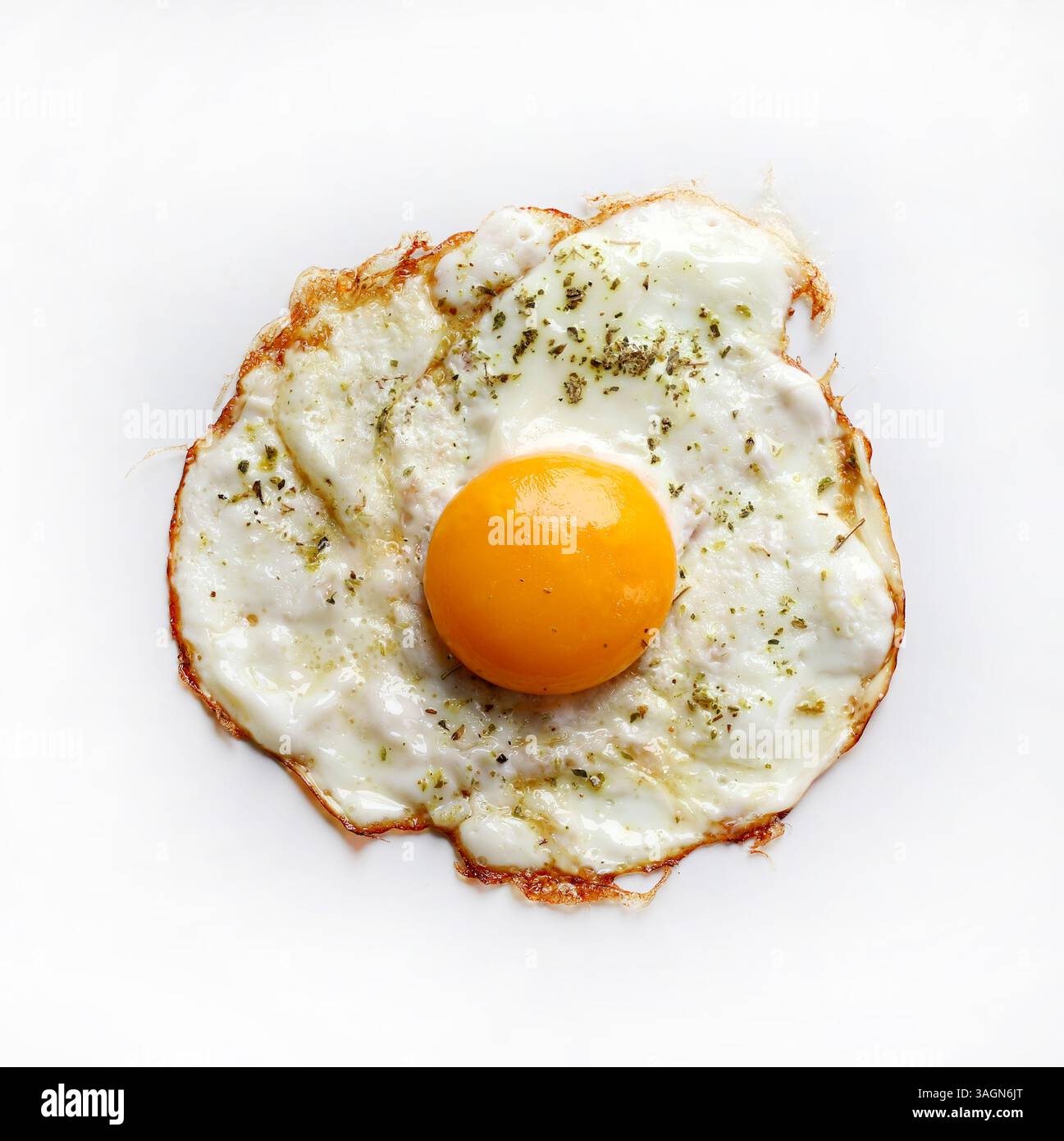 A single fried egg isolated on a white background. Healthy food concept. Directly above. Stock Photo