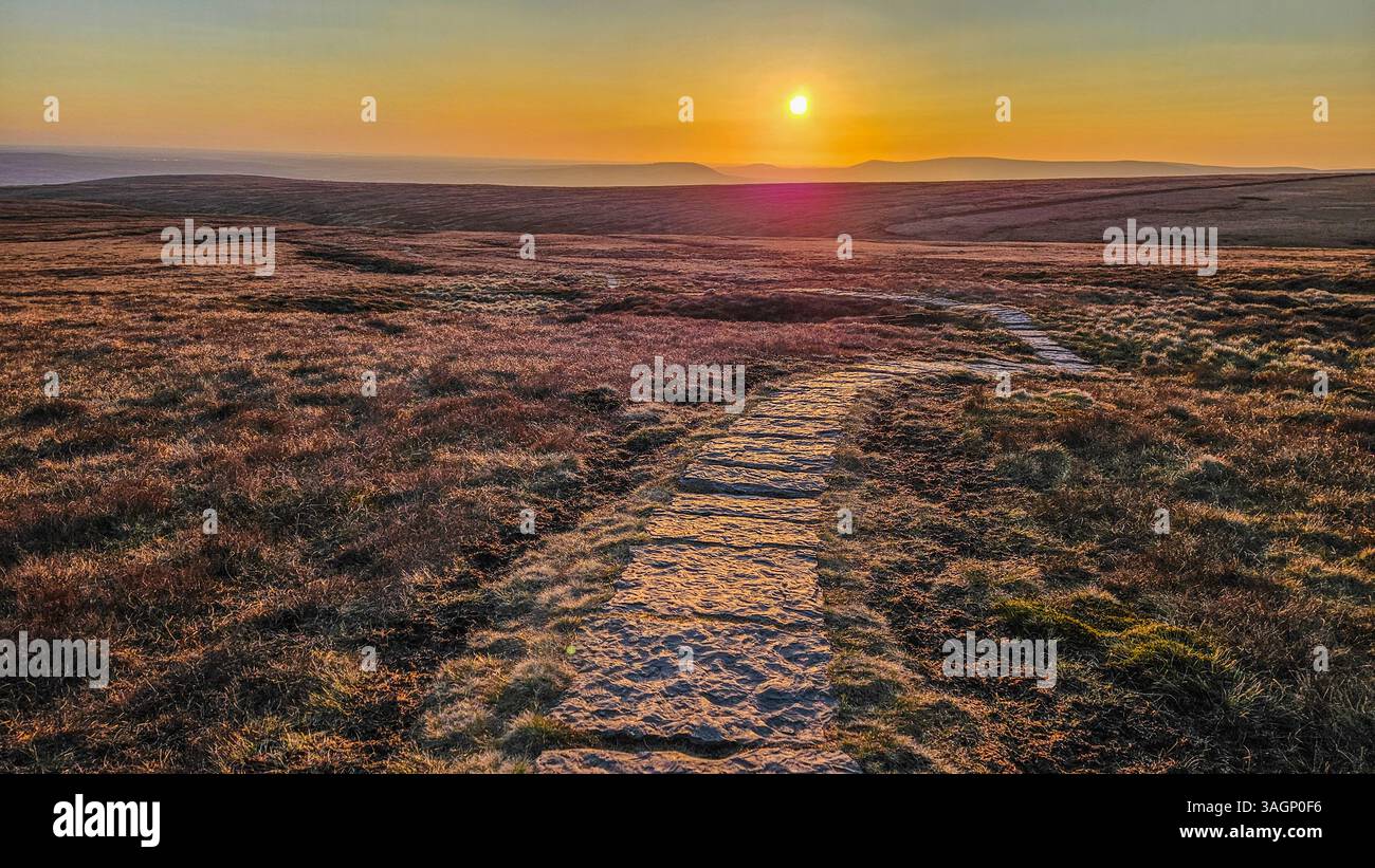 Stone flagged path from Pendle Summit heading west into the spring sunset. - Smartphone Captured Stock Image