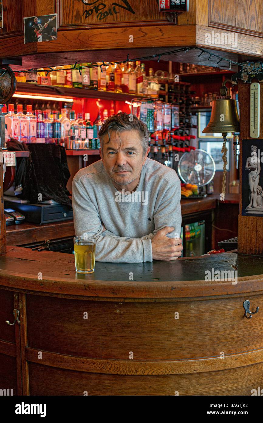 barman serving pint of beer at King Charles I pub , Northdown Street , London Stock Photo