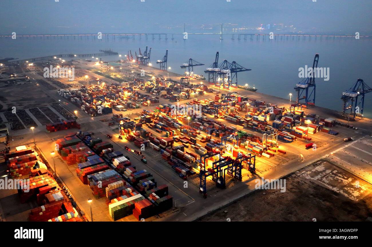 Cargo ships load and unload containers in an orderly manner at the ...