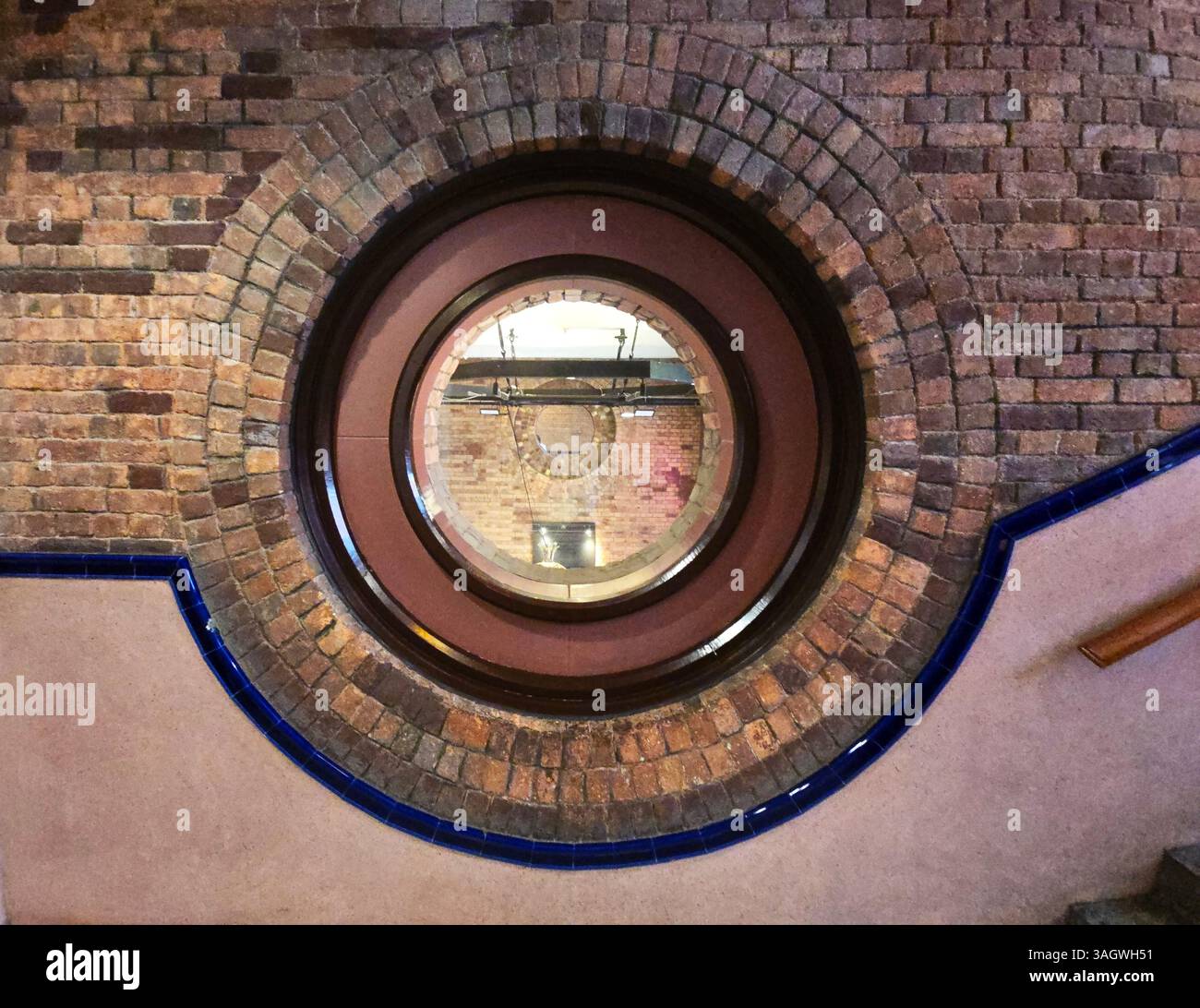 A round window by the staircase at the Western Market building in Sheung Wan, Hong Kong. - Smartphone Captured Stock Image