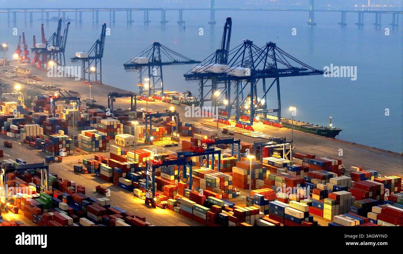 Cargo ships load and unload containers in an orderly manner at the ...