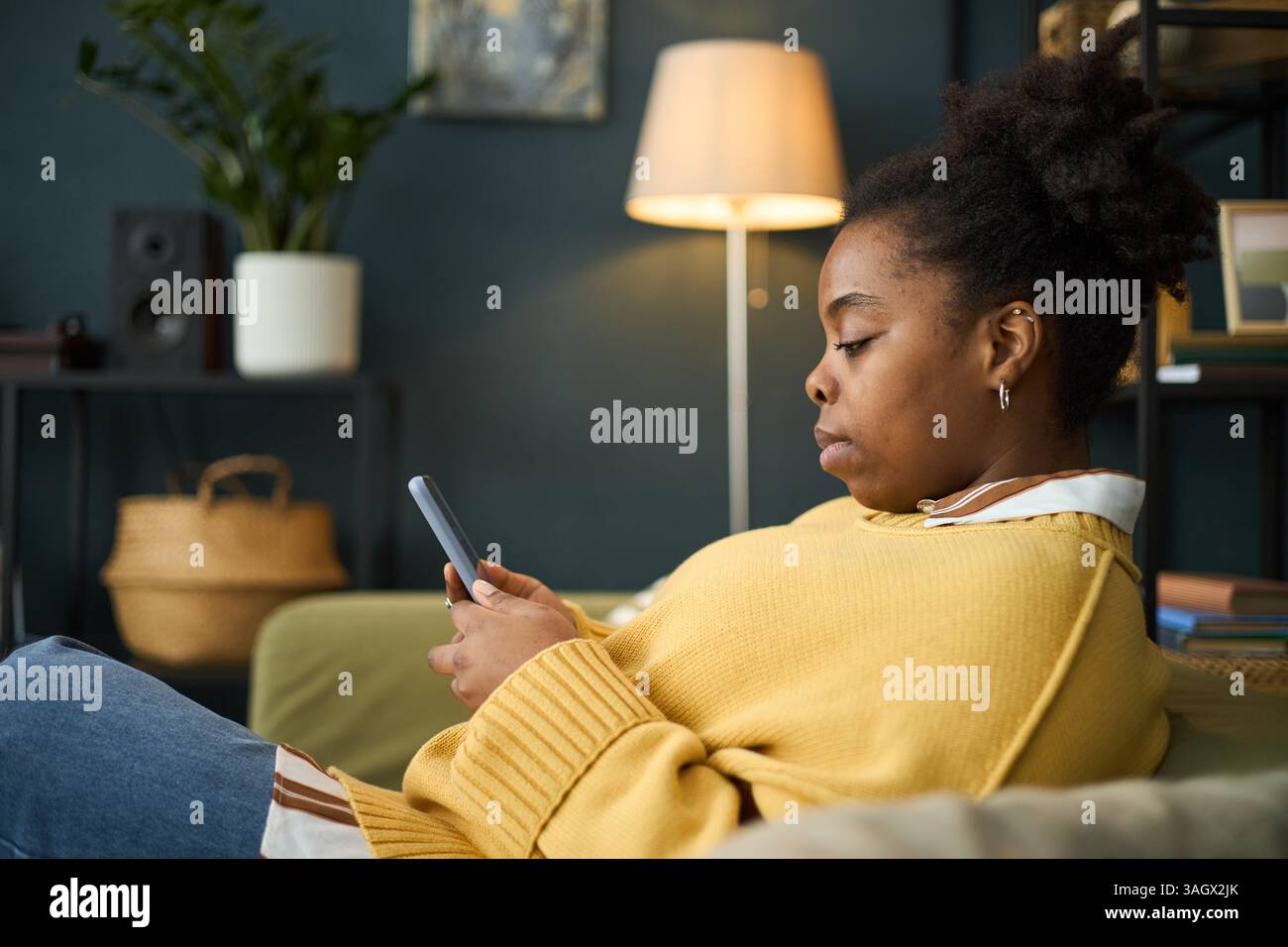 African woman sitting side view hi-res stock photography and images - Alamy
