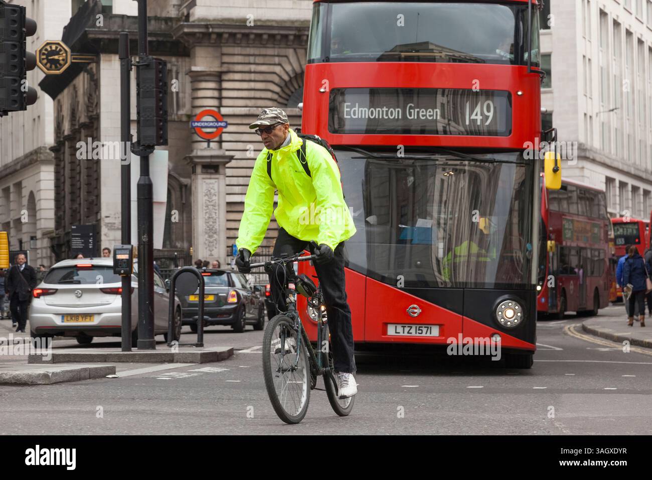 Cyclist and a double decker London bus in the city's financial district ...