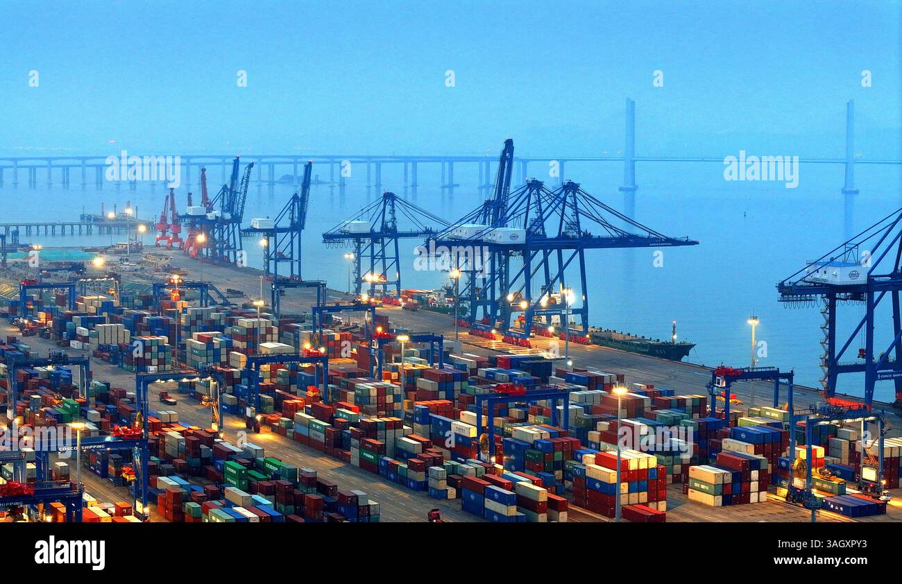 Cargo ships load and unload containers in an orderly manner at the ...