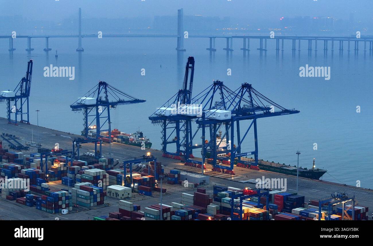 Cargo ships load and unload containers in an orderly manner at the ...