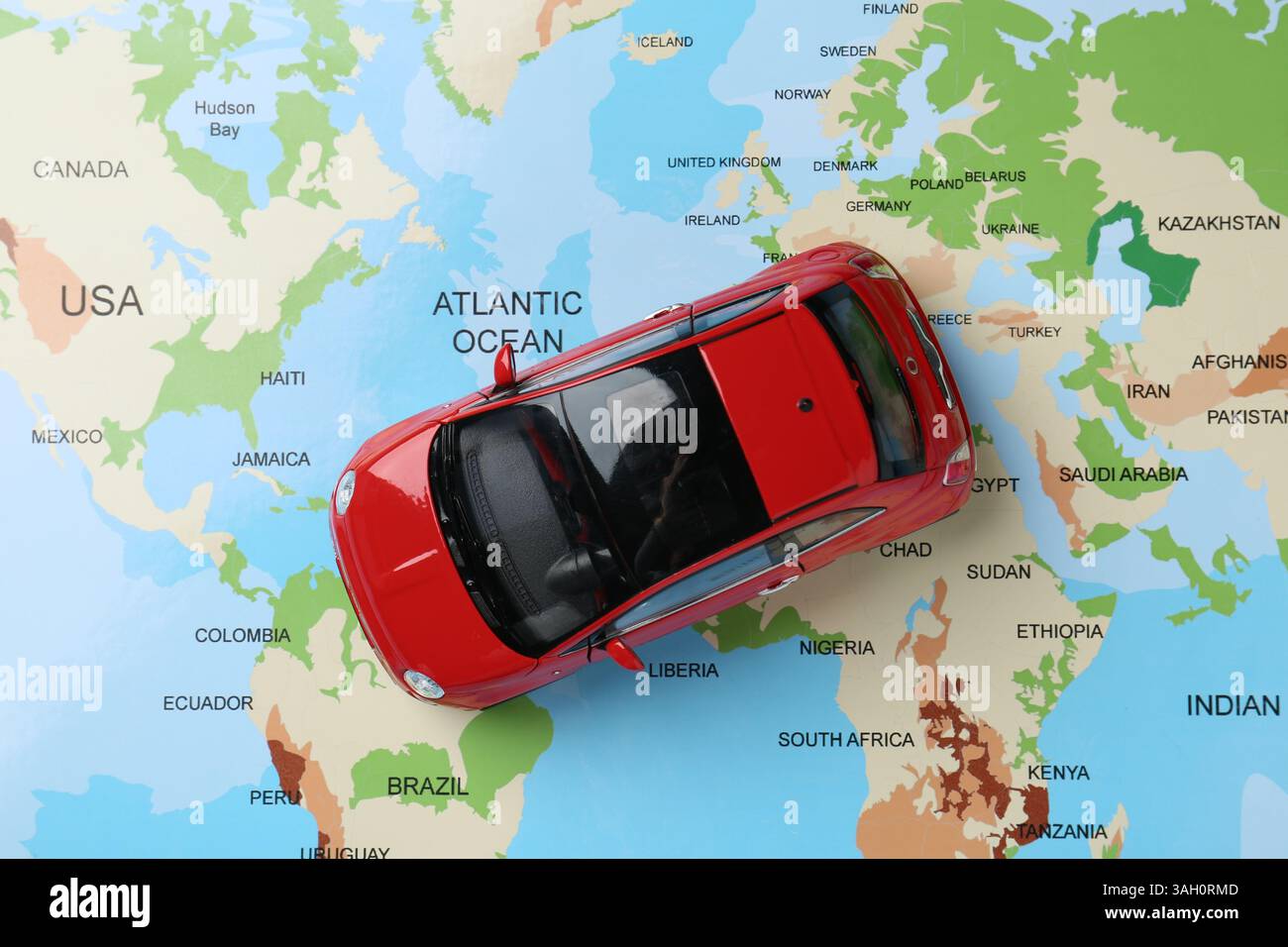 Road trip concept. Car model on world map, top view Stock Photo - Alamy