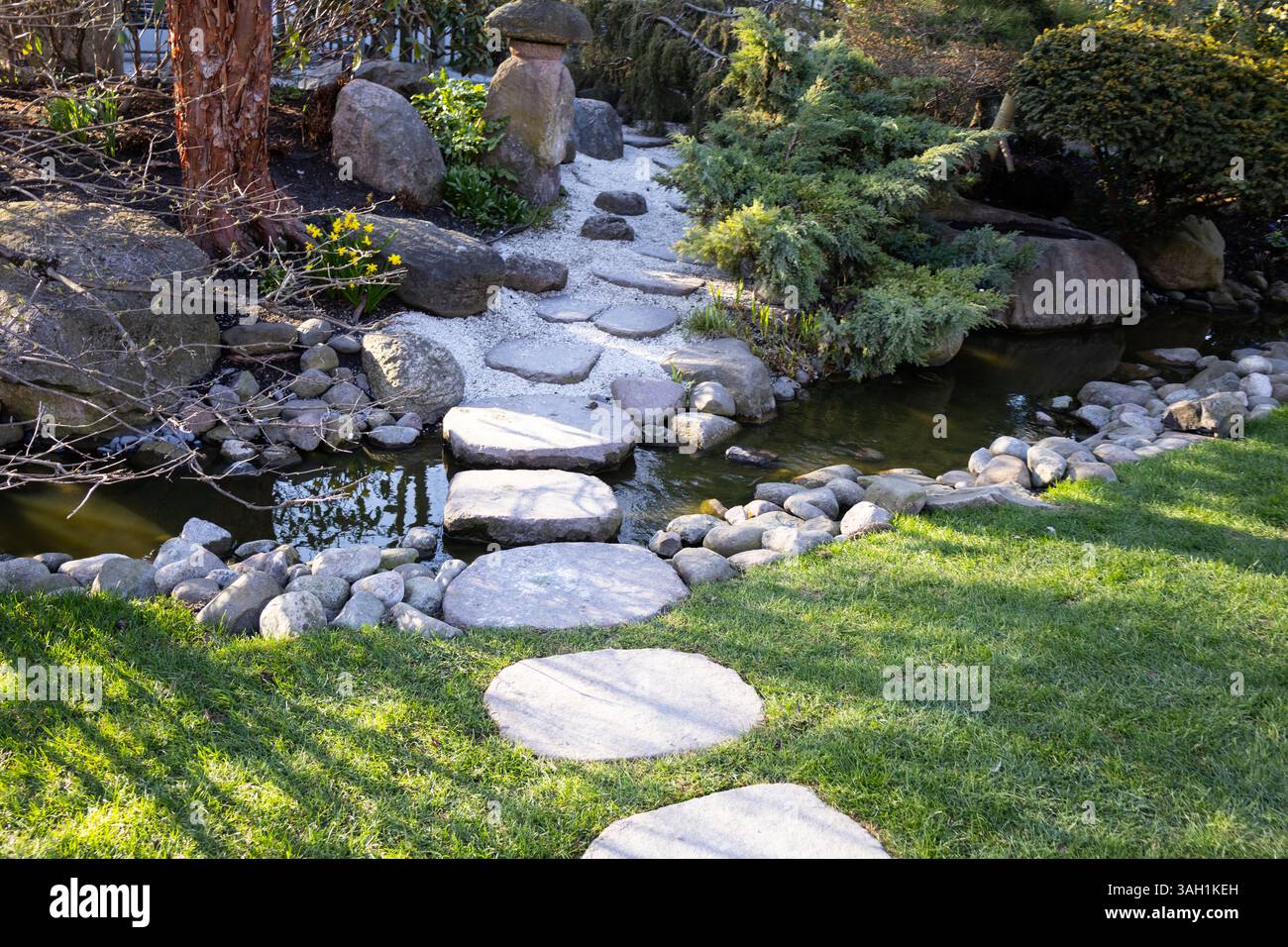 A charming path made of white rocks winding through a green park ...