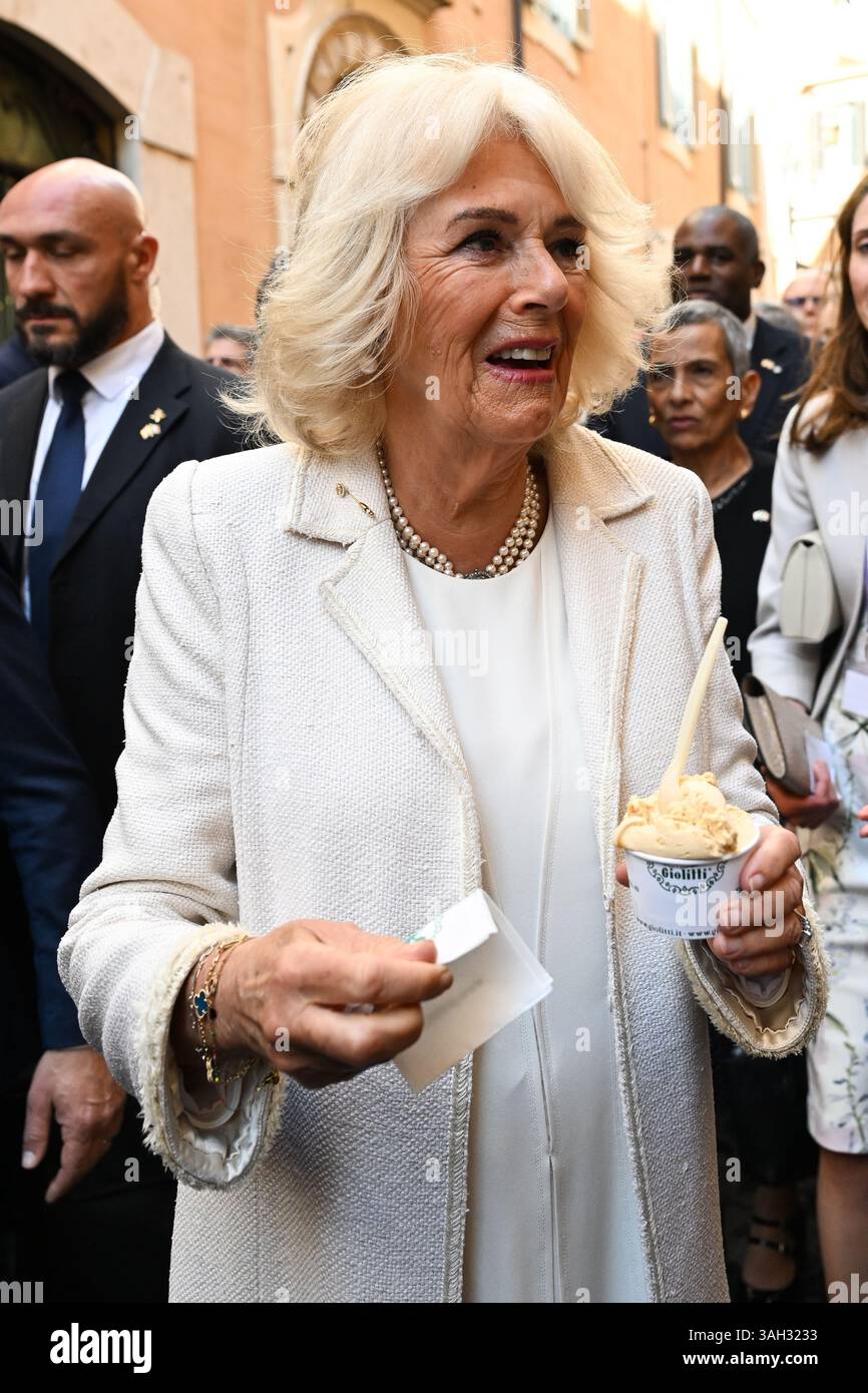 Queen Camilla visits an ice cream parlour while on a walkabout after departing the Italian