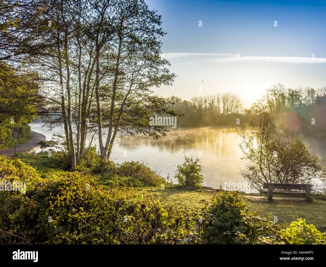 Sunrise over a small lake known as Liden Lagoon in Swindon, Wiltshire. - Smartphone Captured Stock Image