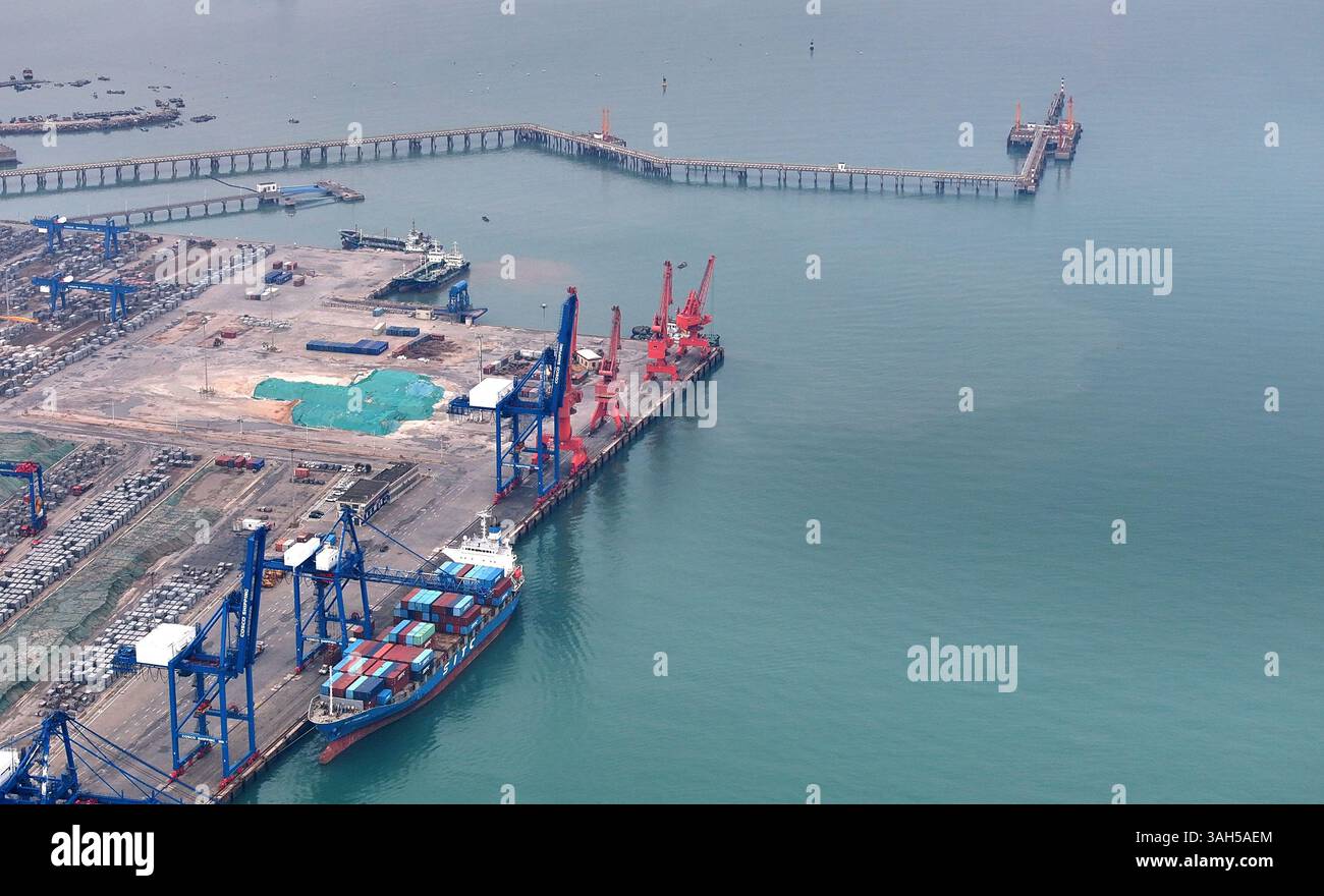 SHISHI, CHINA - APRIL 5, 2025 - Cargo ships load and unload containers ...